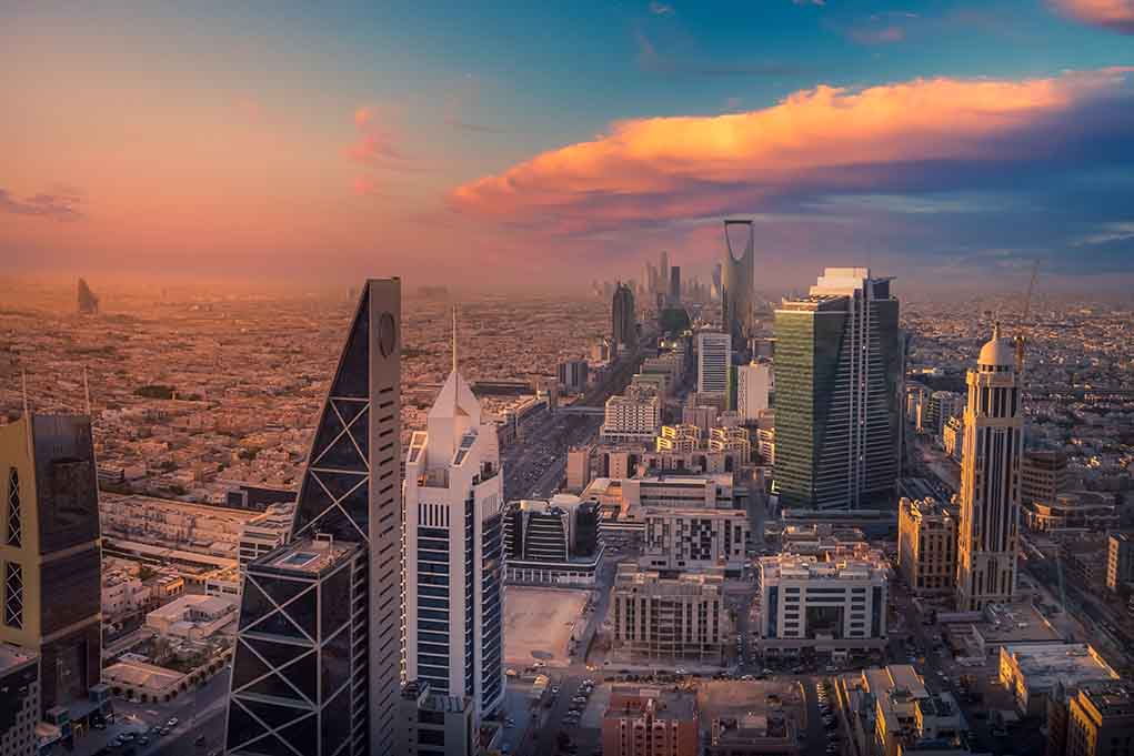 Riyadh skyline at sunset with modern skyscrapers.