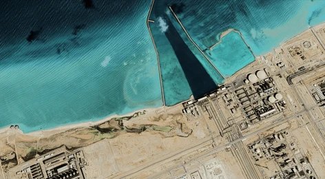 Satellite view of coastal industrial complex with turquoise water