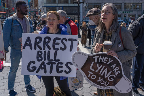 Protesters holding signs at an outdoor demonstration