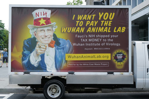 A van with an anti-NIH billboard featuring Anthony Fauci.