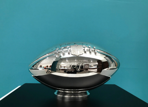 Silver NFL MVP trophy on display.