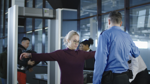 Woman undergoing security check at an airport.