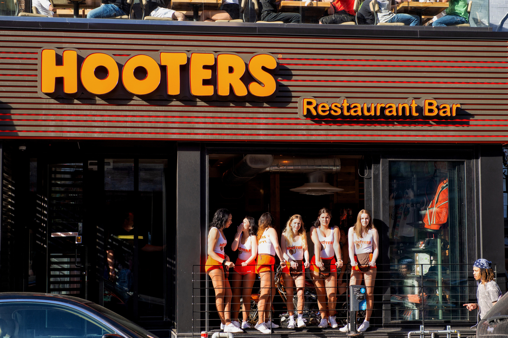 Hooters restaurant with staff standing outside entrance