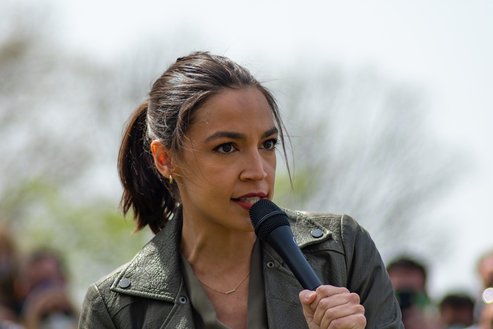 Woman speaking into microphone outdoors event