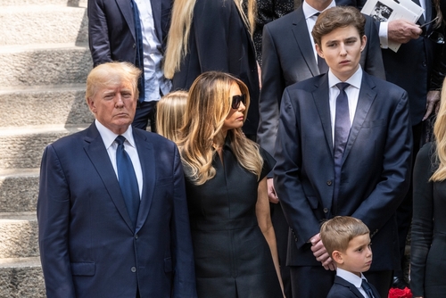 Group of people in formal attire standing outside.