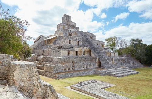 Ancient stone pyramid structure with stairs under a blue sky.