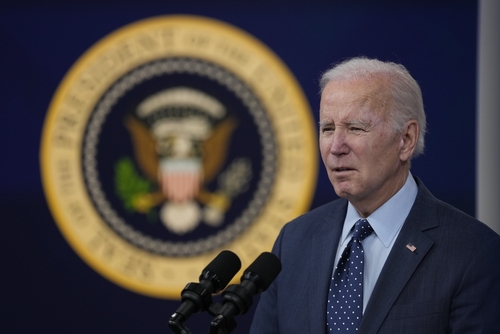 A man speaking in front of presidential seal.