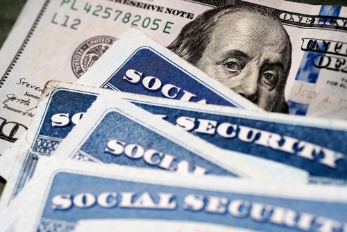 Social Security cards and U.S. one hundred dollar bill.