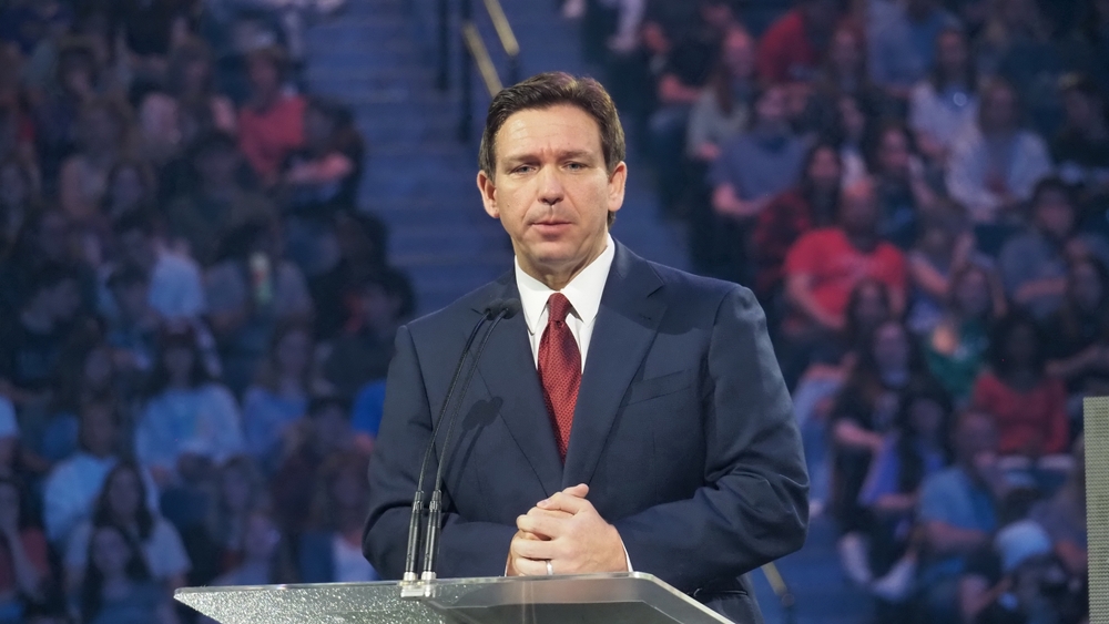 Man speaking at a podium in front of audience