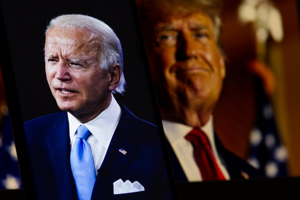Two elderly men in suits with American flags