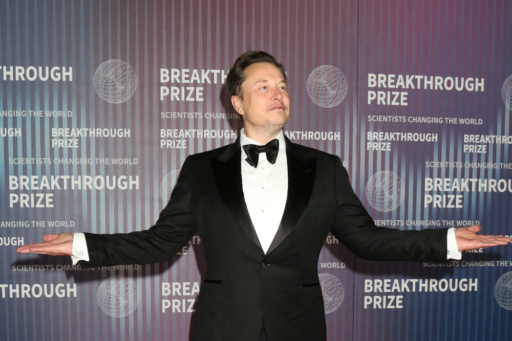 Person in tuxedo posing at Breakthrough Prize event