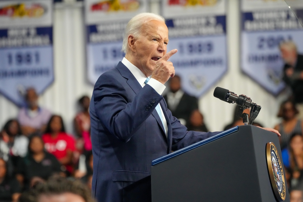 Man speaking at podium during an event indoor audience