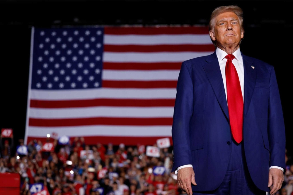 Person standing in front of a large American flag