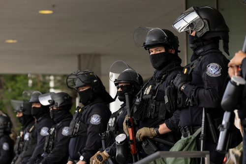 Group of police officers in riot gear standing in formation