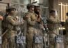 National Guard soldiers in tactical gear standing guard with shields