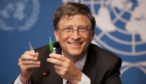A man holding two syringes at a press conference
