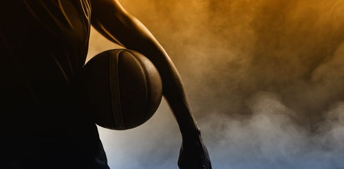 Basketball player silhouette with a ball in hand.