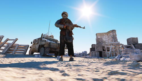 Armed person standing in desert near a military vehicle.