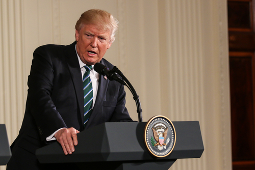 A government official speaking at a podium during a press conference